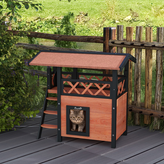 Wooden cat house with a cat peeking out on a deck