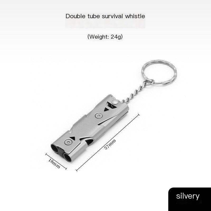 Stainless steel emergency survival whistle on backpack strap for hiking