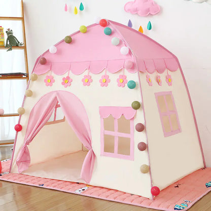 Pink children's play tent with decorative elements on a wooden floor.